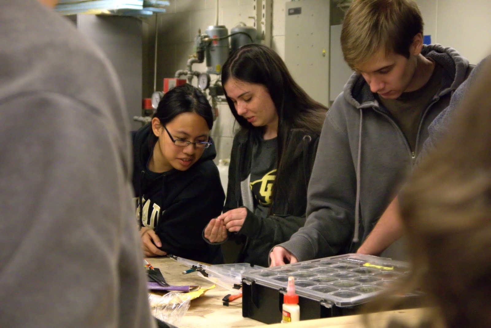 Subteam members building a component in the lab