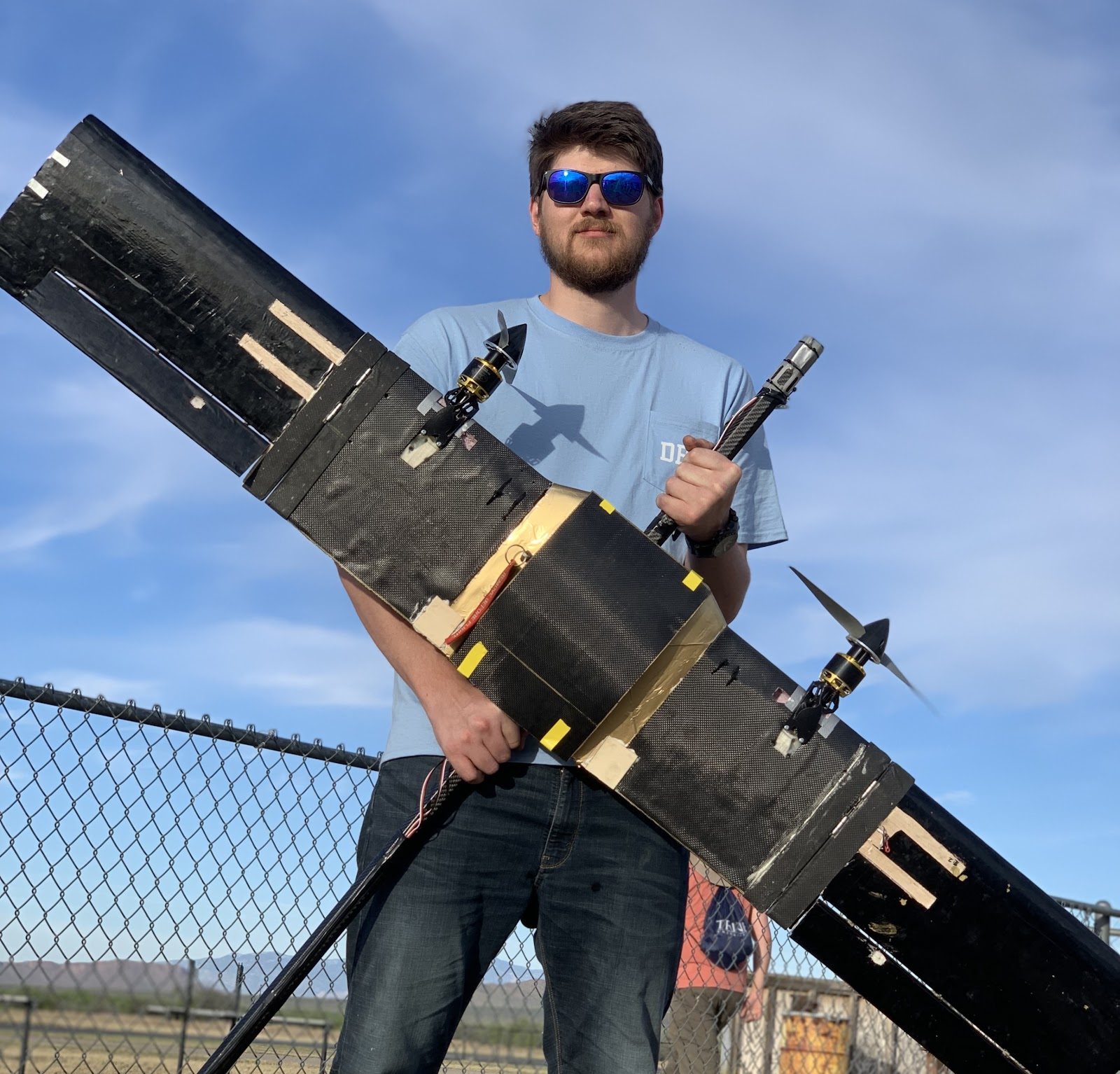 Student holding a laser-cut wing section