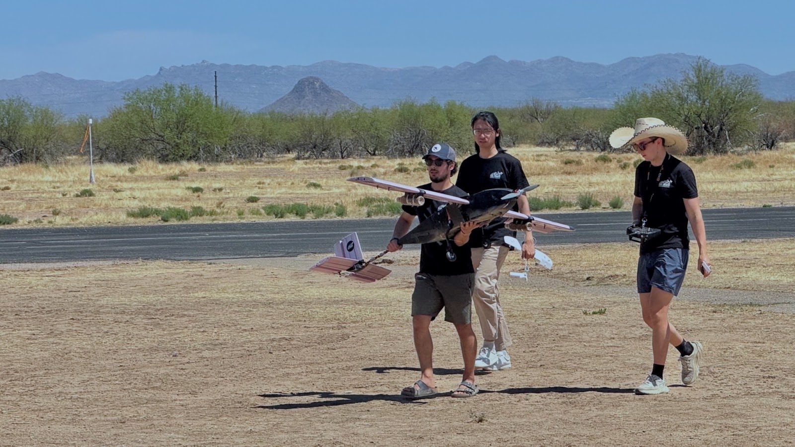 Team members walking the aircraft out to the runway at competition